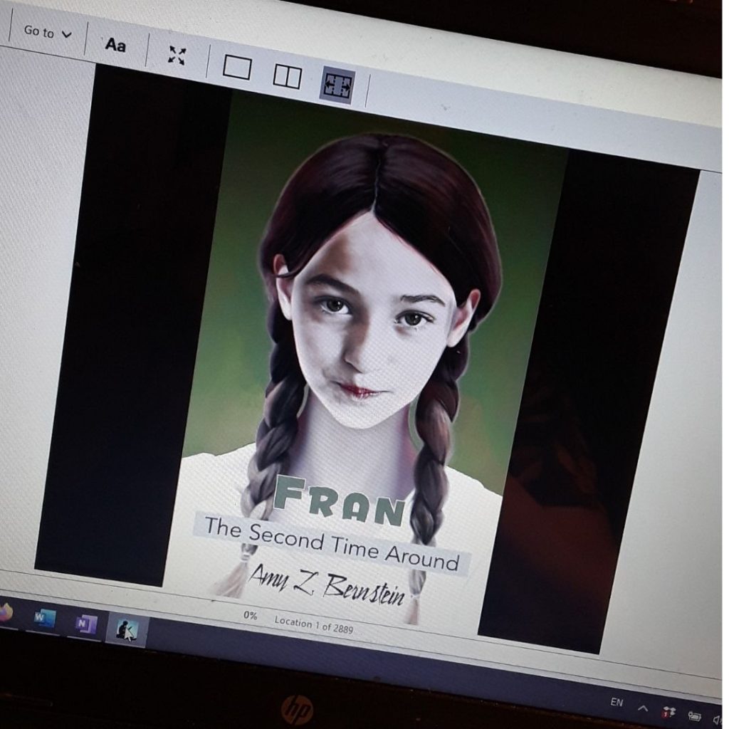 The cover of Fran, the Second Time Around shows on a computer screen. Fran is pictured with a pale face and two braids.
