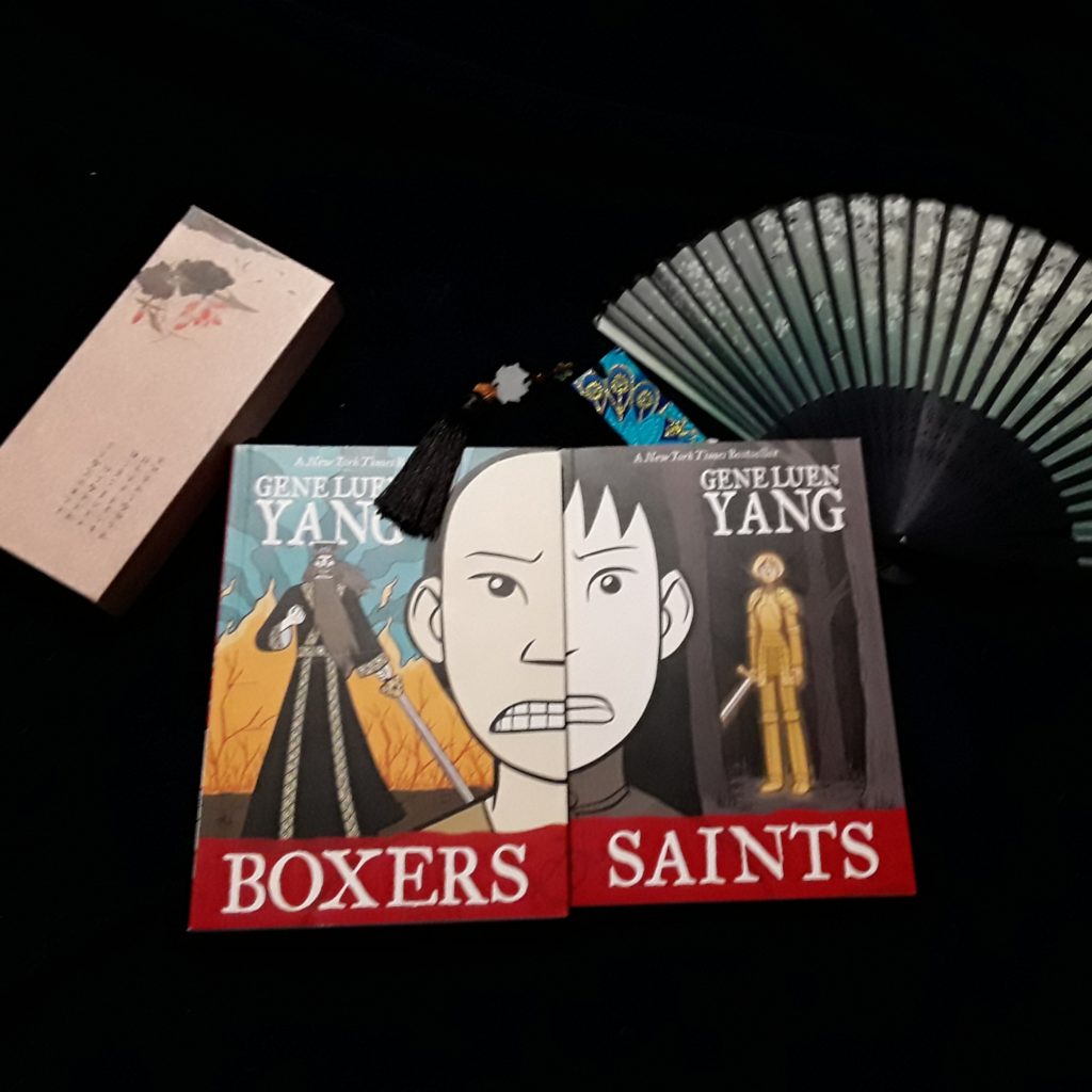 The two volumes of Boxers & Saints sit side by side, so that the faces of the two protagonists merge into one.
