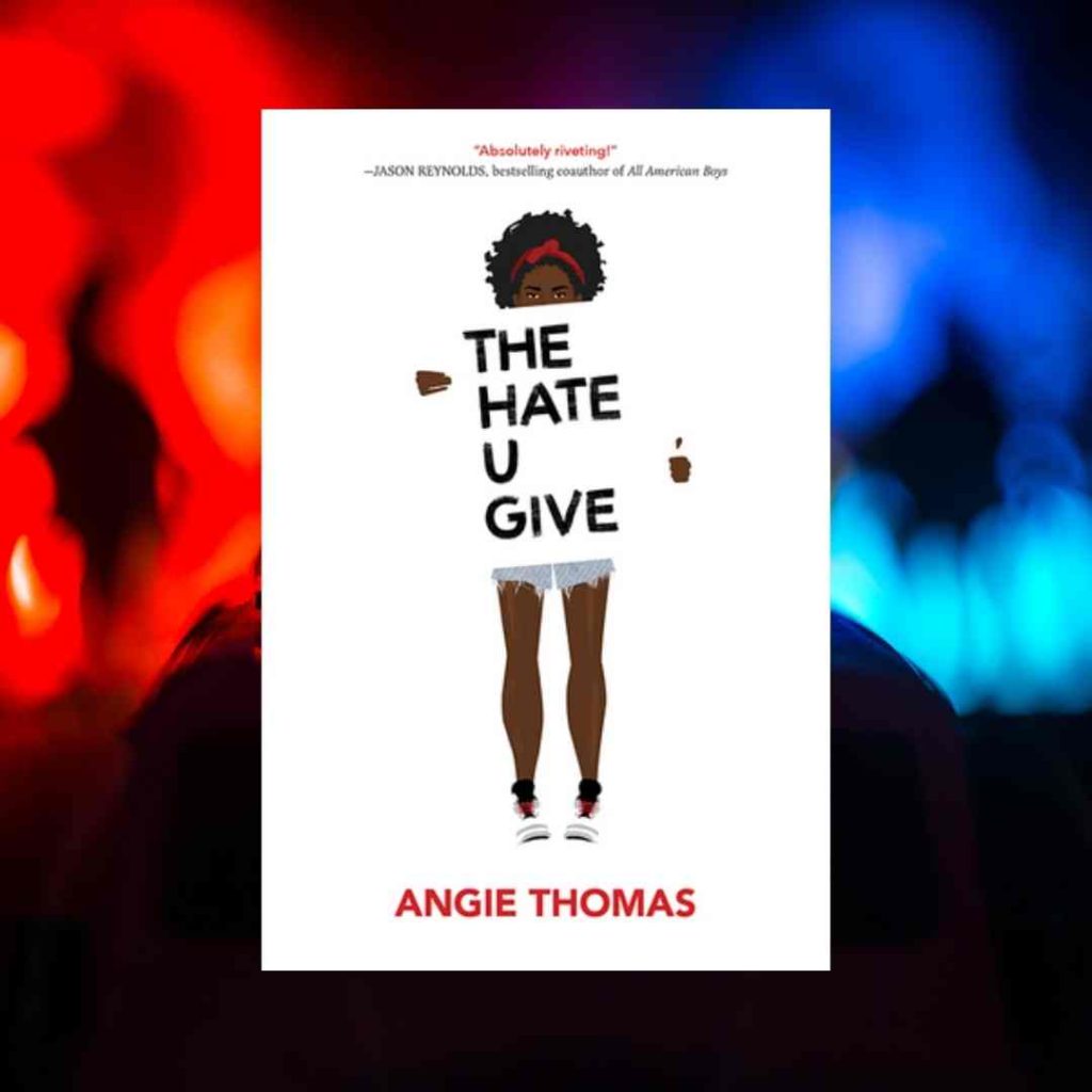 The cover of The Hate U Give sits above swirling police car lights. On the cover, the main character, Starr, who is black, holds a sign, much as one would hold a protest sign, but her sign gives the name of the book.