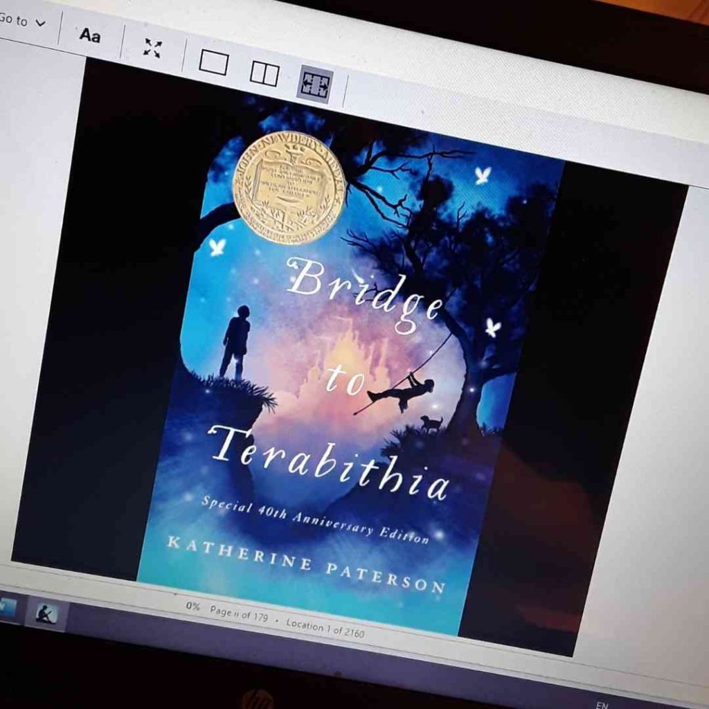 Cover for Bridge to Terabithia by Katherine Patterson (Special 40th anniversary Edition) on a computer screen. Picture--Silhouette of girl swinging on rope from a tree across a gully toward silhouette of boy next to taller tree. Background blues with stars, silhouette of a pink/purple castle foggy in the background.